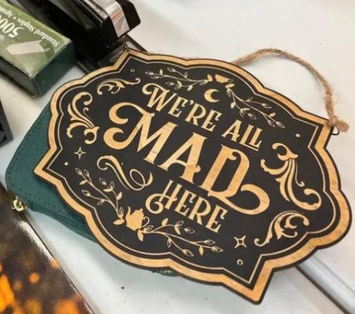 A sign saying "We're all Mad here".